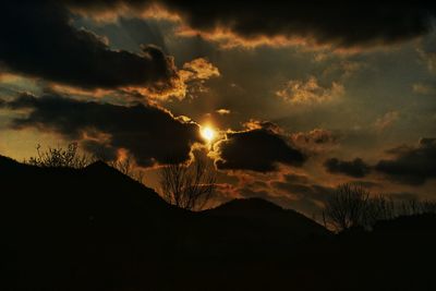 Silhouette landscape against sunset