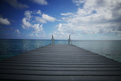 Pier over sea against sky