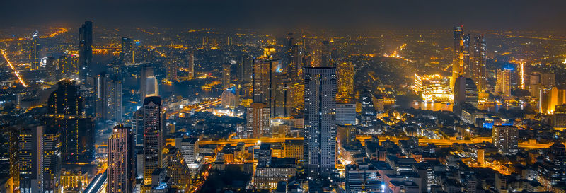 Aerial view of illuminated buildings in city at night