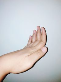 Close-up of hand gesturing against white background