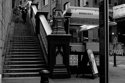 Two people walking down stairs