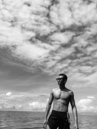 Rear view of man standing at beach