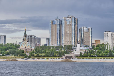 Summer cityscape, samara, russia. sofiyskaya embankment of volga. sculpture boat,cathedral of sophia
