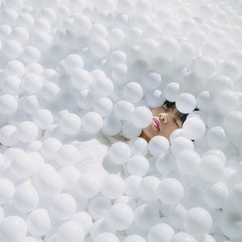 High angle view of woman sleeping amidst balls