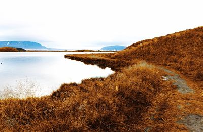 Scenic view of sea and mountains against sky