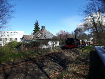 Train on railroad track against sky