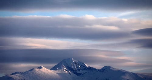 Scenic view of snowcapped mountains against sky during sunset