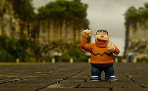 Full length of man with toy standing against trees