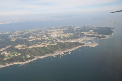 Aerial view of sea and landscape against sky