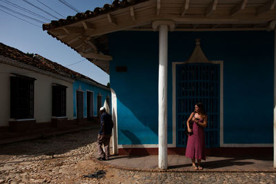 Woman standing against building