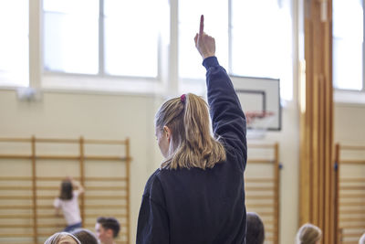 Teacher raising hand during pe class