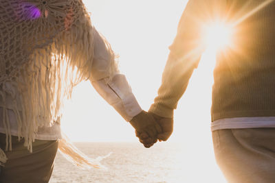 Sun shining through hands