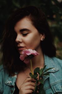 Close-up of woman with roses in sunlight