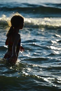 Side view of people in water