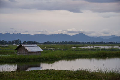 Scenic view of lake by buildings against sky