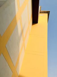 Low angle view of yellow building against sky