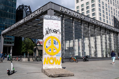 Information sign on street against buildings in city