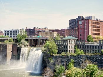 View of waterfall against buildings