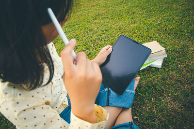 High angle view of woman using mobile phone in field