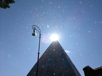 Low angle view of illuminated street light against sky at night