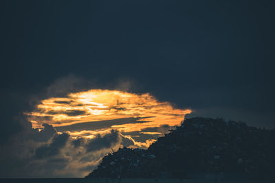 Low angle view of dramatic sky during sunset