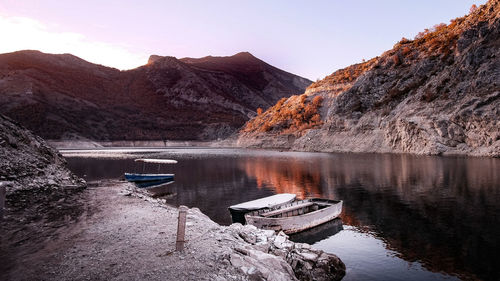 Scenic view of lake and mountains against clear sky