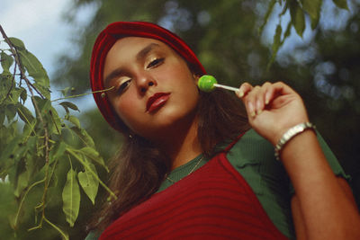 Close-up portrait of teenage girl eating lollipop