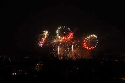 Low angle view of firework display at night