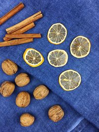 High angle view of lemon and walnuts by cinnamon on table