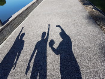 Shadow of people on road