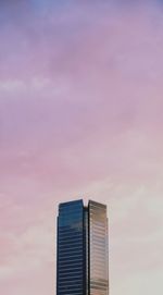 Modern building against sky during sunset