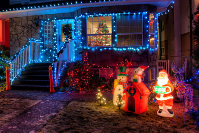 Illuminated christmas lights on building at night