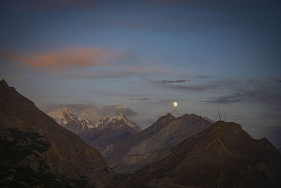 Scenic view of snowcapped mountains against sky during sunset