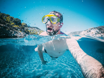 Man in swimming pool against sea