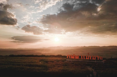 Scenic view of field against sky during sunset