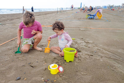 Children playing with toy on beach