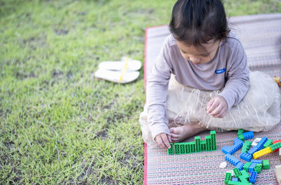 High angle view of boy sitting on hay