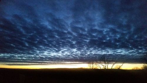 Scenic view of dramatic sky over field