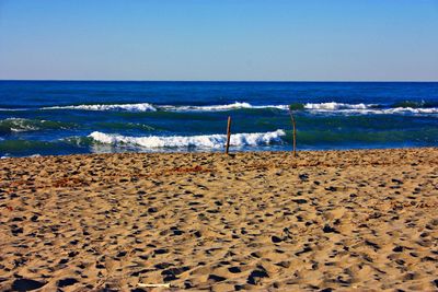 Scenic view of beach against clear sky