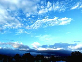 Scenic view of mountains against cloudy sky