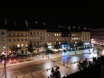 Illuminated city against sky at night