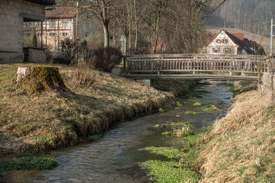 Bridge over canal amidst buildings