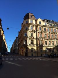 View of buildings against clear blue sky