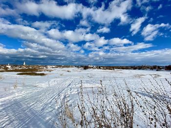 Snow covered field against sky