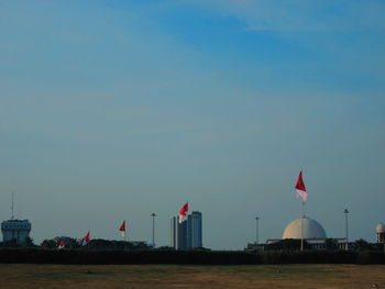 Beach against clear sky in city