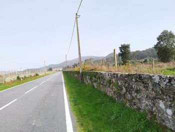 Empty road against clear sky