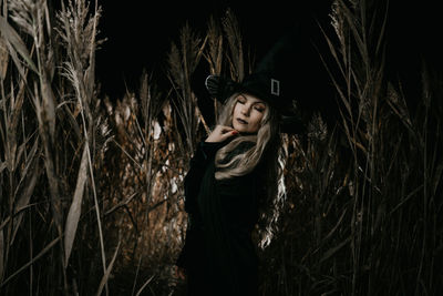 Portrait of woman standing by plants