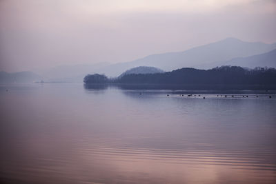 Scenic view of lake against sky during sunset