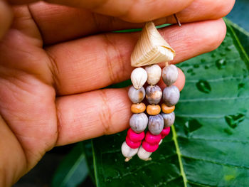 Close-up of woman holding colorful earring