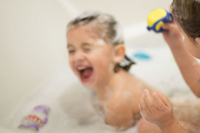 Close-up of mother and daughter in bathroom